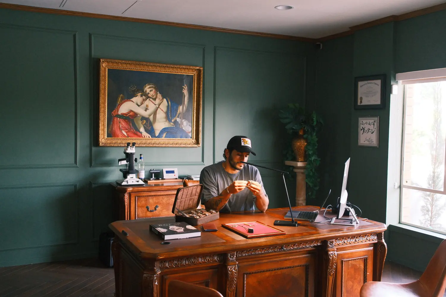 Serge, founder of Finer Finds, examining a timepiece in the Beverly Hills office